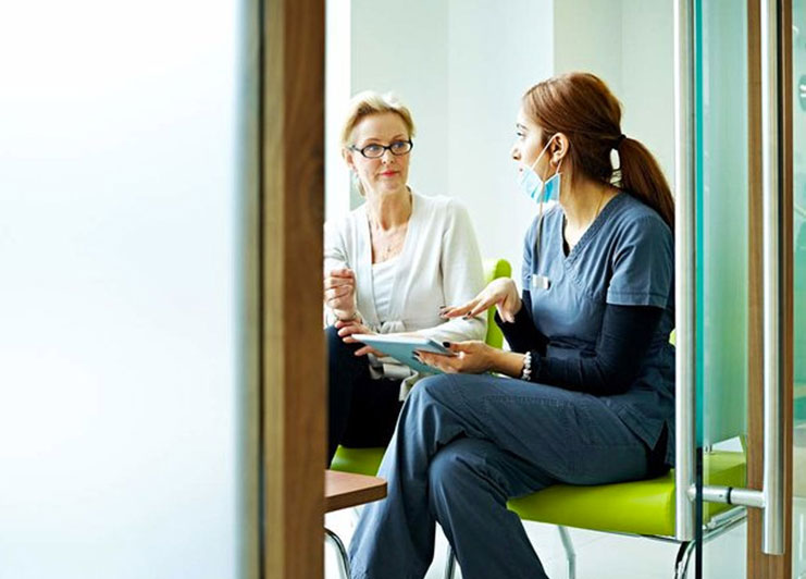 woman-dentist-conversing-with-patient